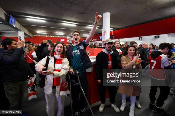 Arsenal fans celebrate in the concourse after Liverpool lose 0-1 to Crystal Palace prior to the Premier League match between Arsenal FC and Aston...