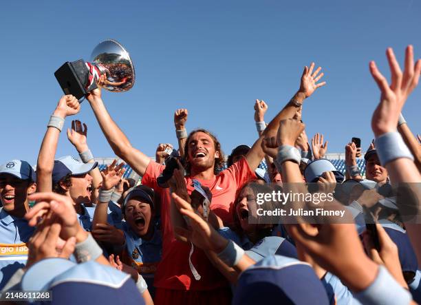 Stefanos Tsitsipas of Greece celebrates with the trophy and ball kids after his victory over Casper Ruud of Norway in the Men's Final on day eight of...