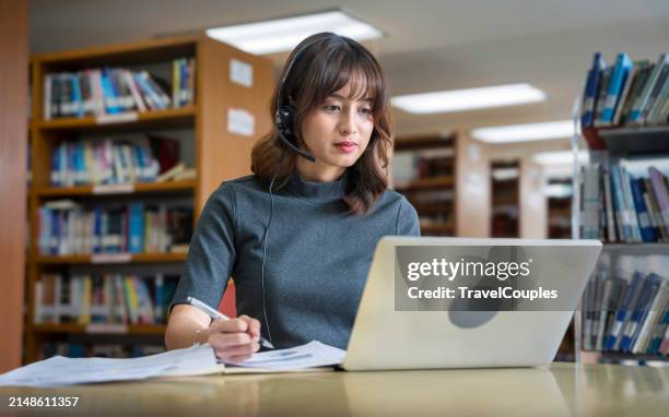 asian woman student video conference e-learning with teacher on computer laptop at library. back to school education knowledge college university concept. young women working and used computer laptop. - tutorial stock pictures, royalty-free photos & images