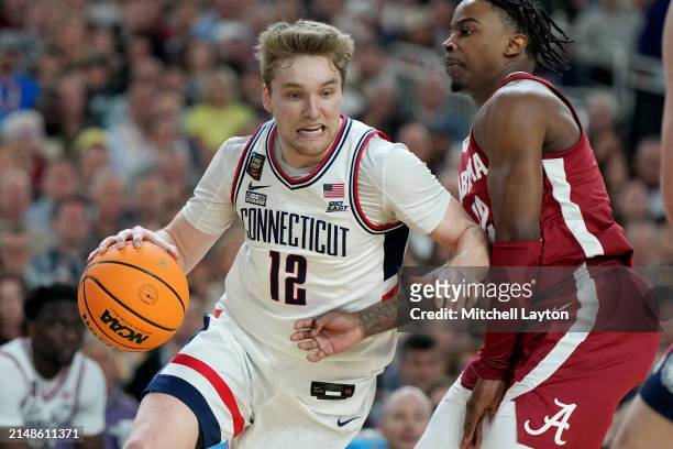 Cam Spencer of The Connecticut Huskies dribbles the ballt during the NCAA Mens Basketball Tournament Final Four semifinal game against the Alabama...
