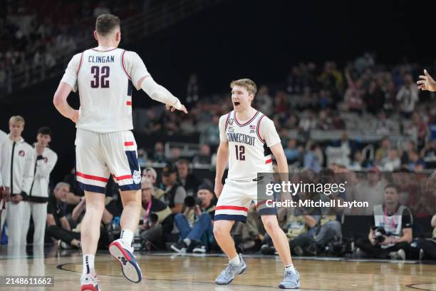 Donovan Clingan and Cam Spencer of The Connecticut Huskies celebrate a win during the NCAA Mens Basketball Tournament Final Four semifinal game...