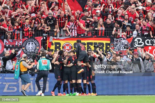 Players of Bayer Leverkusen celebrate their team's third goal scored by Florian Wirtz of Bayer Leverkusen during the Bundesliga match between Bayer...