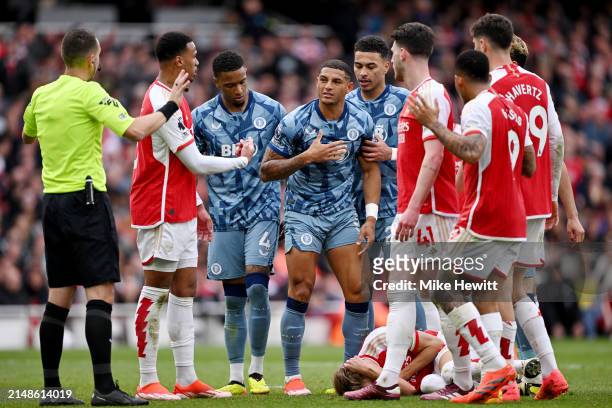 Diego Carlos of Aston Villa apologises after clash with Martin Odegaard of Arsenal during the Premier League match between Arsenal FC and Aston Villa...