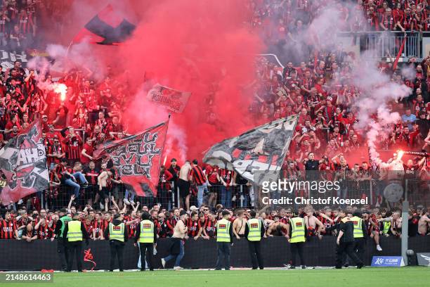 The game is paused after fans of Bayer Leverkusen set off flares and invade the pitch after Florian Wirtz of Bayer Leverkusen scores his team's...