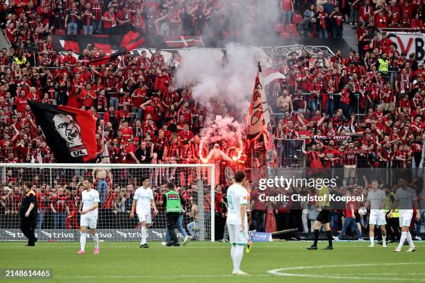 The game is paused after fans of Bayer Leverkusen set off flares and invade the pitch after Florian Wirtz of Bayer Leverkusen scores his team's...