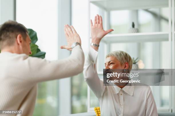 celebratory high-five - high five stockfoto's en -beelden