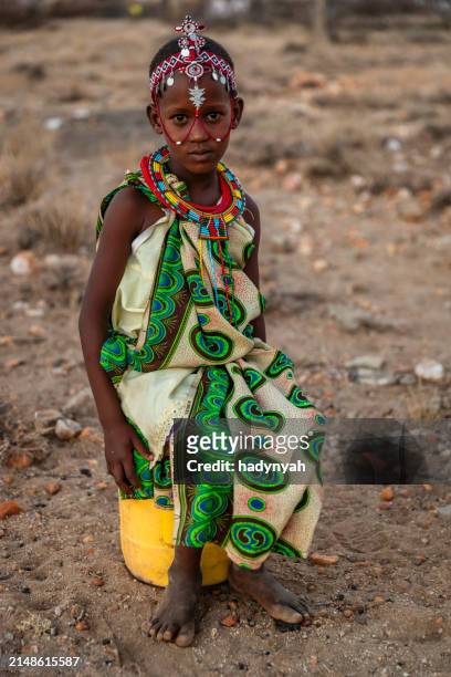 african little girl carrying water from the well, kenya, africa. - east african tribe stock pictures, royalty-free photos & images