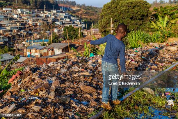 african little boy walking on railroad tracks, kibera slum on the background, kenya, east africa - nairobi county stock pictures, royalty-free photos & images