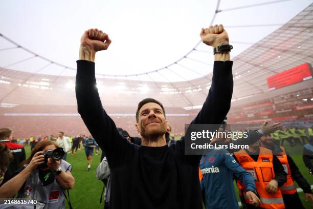 Xabi Alonso, Head Coach of Bayer Leverkusen, celebrates after the team's victory and winning the Bundesliga title for the first time in their history...