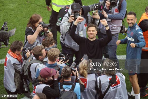 Xabi Alonso, Head Coach of Bayer Leverkusen, celebrates after the team's victory and winning the Bundesliga title for the first time in their history...