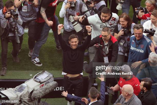 Xabi Alonso, Head Coach of Bayer Leverkusen, celebrates after the team's victory and winning the Bundesliga title for the first time in their history...