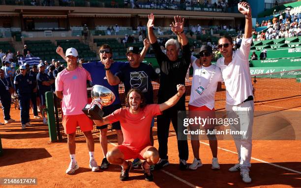 Stefanos Tsitsipas of Greece poses for a photograph with the trophy alongside family and team members after his victory over Casper Ruud of Norway in...