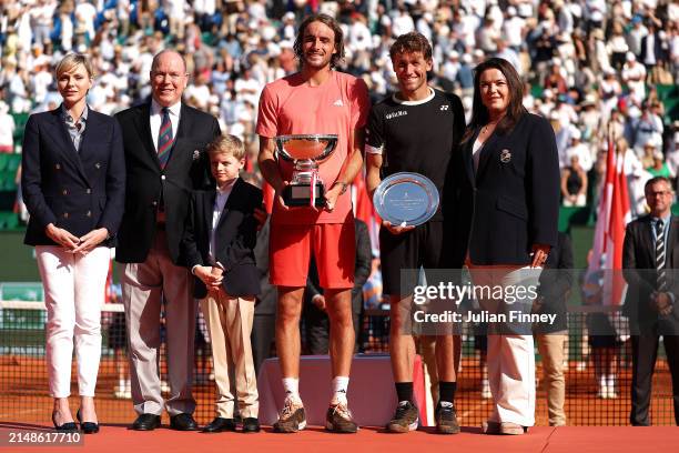 Stefanos Tsitsipas of Greece holds his trophy as he speaks on court alongside Charlene, Princess of Monaco, Prince Albert II of Monaco, Prince...