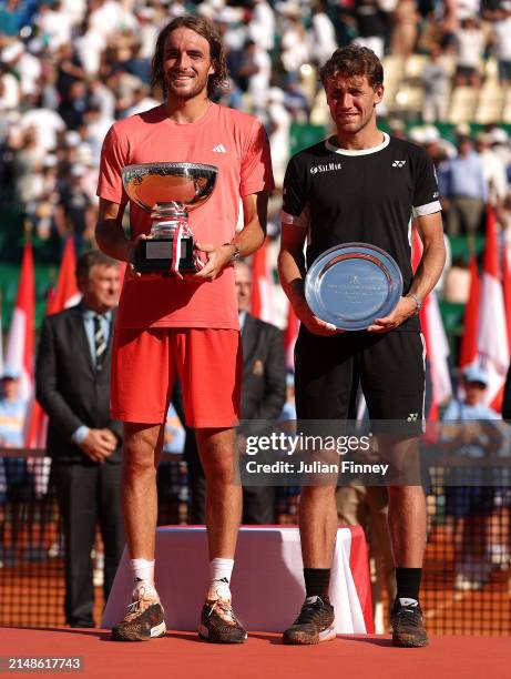 Stefanos Tsitsipas of Greece holds his trophy alongside runner up Casper Ruud of Norway after his victory in the Men's Final on day eight of the...