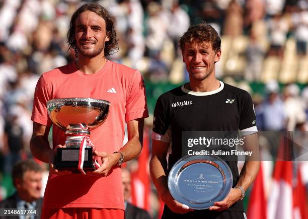 Stefanos Tsitsipas of Greece holds his trophy alongside runner up Casper Ruud of Norway after his victory in the Men's Final on day eight of the...