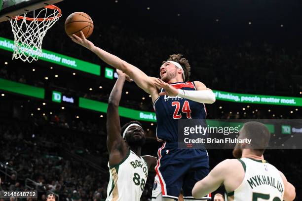 Corey Kispert of the Washington Wizards attempts a basket against Neemias Queta of the Boston Celtics and Svi Mykhailiuk during the second quarter at...