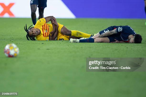 Jules Koundé of Barcelona and Nuno Mendes of Paris Saint-Germain after colliding during the Paris Saint-Germain V Barcelona, UEFA Champions League,...
