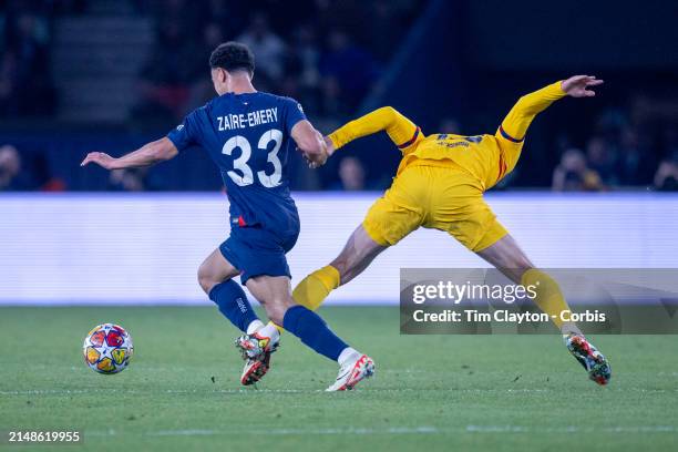 Warren Zaire-Emery of Paris Saint-Germain is fouled by Andreas Christensen of Barcelona, resulting in a yellow card during the Paris Saint-Germain V...