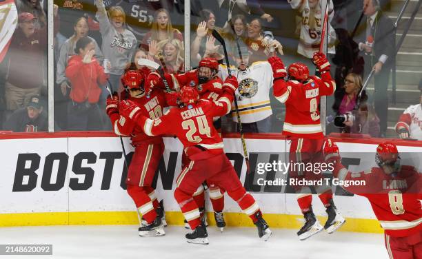 Jared Wright of the Denver Pioneers celebrates with teammates Kieran Cebrian, Boston Buckberger and Rieger Lorenz after he scored against the Boston...