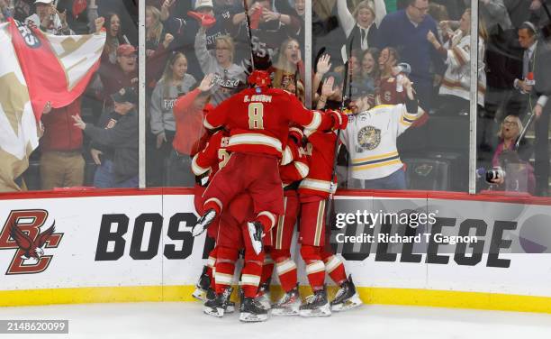 Jared Wright of the Denver Pioneers celebrates with teammates Kieran Cebrian, Boston Buckberger, Shai Buium and Rieger Lorenz after he scored against...