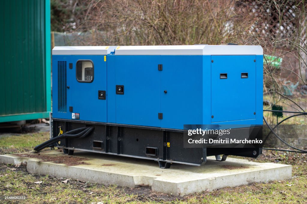 Mobile backup diesel generator for uninterrupted power supply installed near private house outdoors