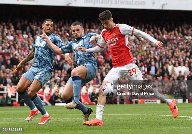 Kai Havertz of Arsenal under pressure from John McGinn and Diego Carlos of Villa during the Premier League match between Arsenal FC and Aston Villa...