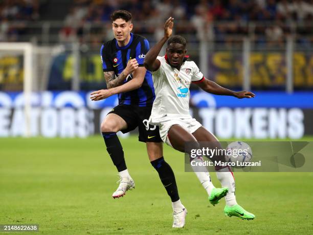 Zito Luvumbo of Cagliari Calcio is challenged by Alessandro Bastoni of FC Internazionale during the Serie A TIM match between FC Internazionale and...