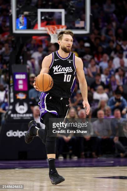 Domantas Sabonis of the Sacramento Kings dribbles the ball against the LA Clippers at Golden 1 Center on April 02, 2024 in Sacramento, California....