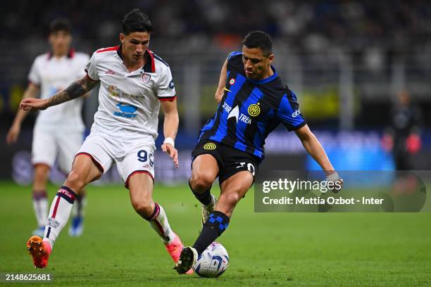 Alexis Sanchez of FC Internazionale, in action, is challenged by Alessandro Di Pardo of Cagliari during the Serie A TIM match between FC...