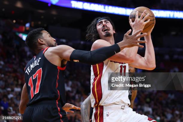 Jaime Jaquez Jr. #11 of the Miami Heat drives against Garrett Temple of the Toronto Raptors during the first quarter of the game at Kaseya Center on...