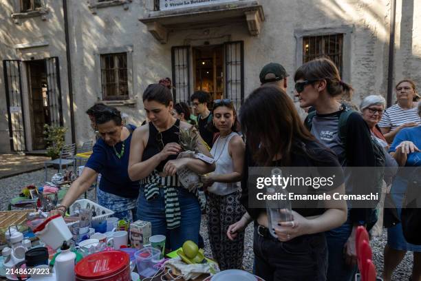 People look and snoop at second hand items during a swap event organized by the NPO Stooping Milano at Cascina Cuccagna on April 14, 2024 in Milan,...