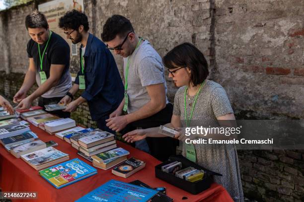 Volunteers of the NPO Stooping Milano place second hand books during a swap event at Cascina Cuccagna on April 14, 2024 in Milan, Italy. Various...