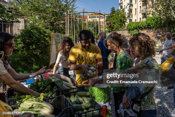 Volunteers of the Italian NPO Recup - which collects unsold and leftover food surplus from the market stands in order to fight food loss and waste -...