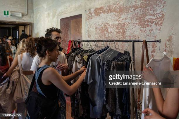 People take part in a clothing swap event organized by the NPO Humana People to People at Cascina Cuccagna on April 14, 2024 in Milan, Italy. Various...