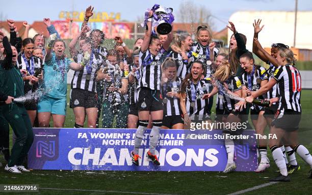 Amber-Keegan Stobbs of Newcastle United lifts The FA Women's National League Northern Premier Division trophy after the team's victory in The FA...