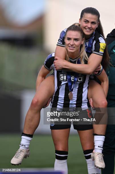 Newcastle United players Emma Kelly and Elysia Boddy celebrate after winning The FA Women's National League Northern Premier Division trophy after...