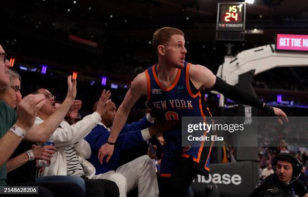 Donte DiVincenzo of the New York Knicks falls into the first row of fans as he chased a loose ball during the first half at Madison Square Garden on...