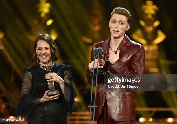 Dame Arlene Phillips and James Cousins with the Gillian Lynne Award for Best Theatre Choreographer on stage during The Olivier Awards 2024 at The...