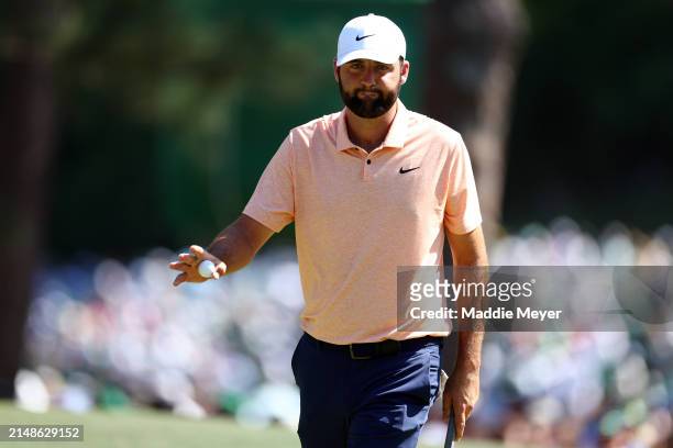 Scottie Scheffler of the United States reacts after making par on the sixth green during the final round of the 2024 Masters Tournament at Augusta...