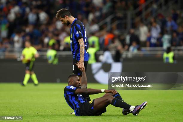 Marcus Thuram of FC Internazionale is helped up by Francesco Acerbi after the Serie A TIM match between FC Internazionale and Cagliari at Stadio...