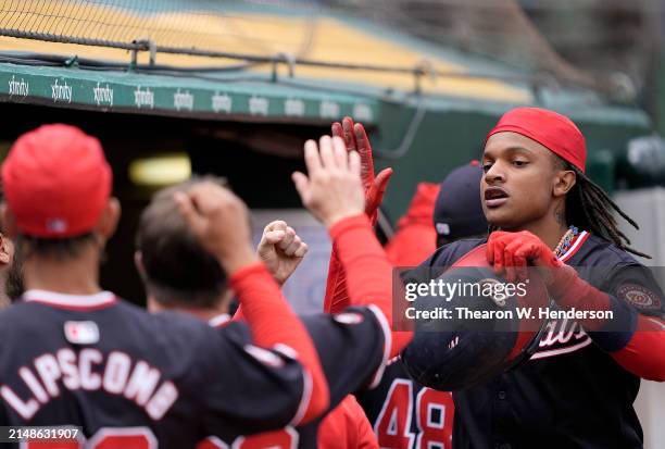 Abrams of the Washington Nationals is congratulated by teammates after he scored against the Oakland Athletics in the top of the third inning on...
