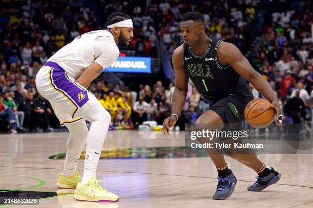 Zion Williamson of the New Orleans Pelicans is defended by Anthony Davis of the Los Angeles Lakers during a game at Smoothie King Center on April 14,...