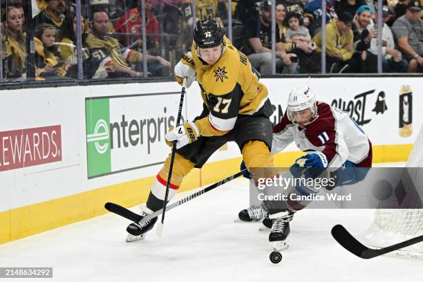 Ben Hutton of the Vegas Golden Knights and Andrew Cogliano of the Colorado Avalanche chase after the puck in the first period at T-Mobile Arena on...