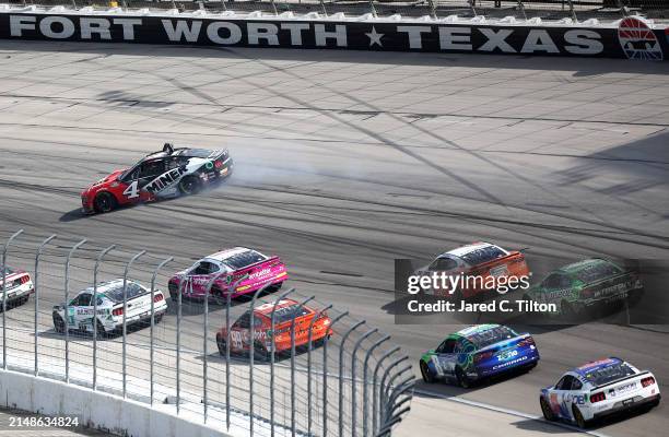 Josh Berry, driver of the Miner Docks Doors And More Ford, spins after an on-track incident during the NASCAR Cup Series AutoTrader EchoPark...