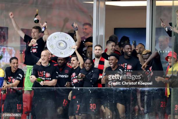 Player of Leverkusen celebrate after their team's victory and winning the Bundesliga title for the first time in their history after the Bundesliga...