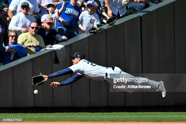 Dylan Moore of the Seattle Mariners dives for a ball in left field during the seventh inning against the Chicago Cubs at T-Mobile Park on April 14,...