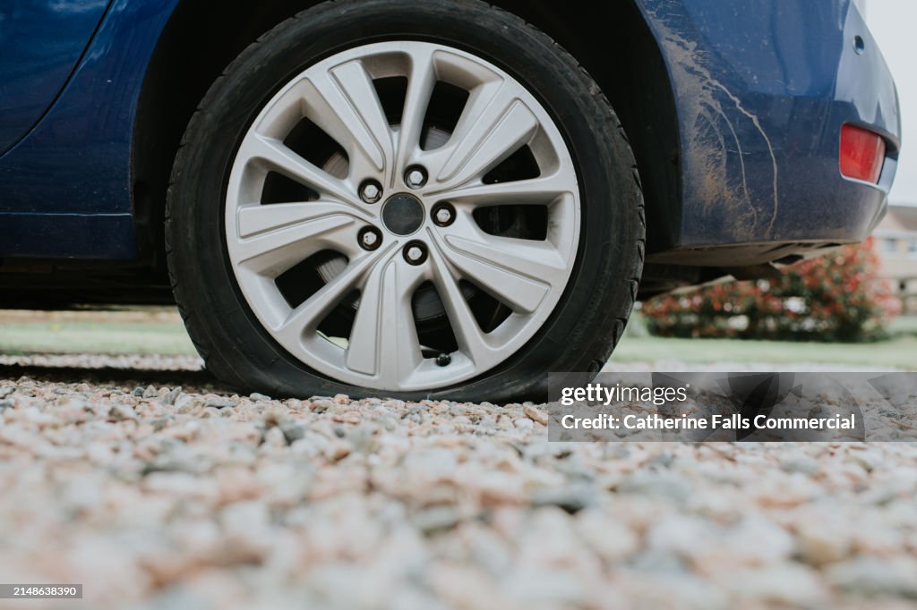 Close-up of a car's flat tire