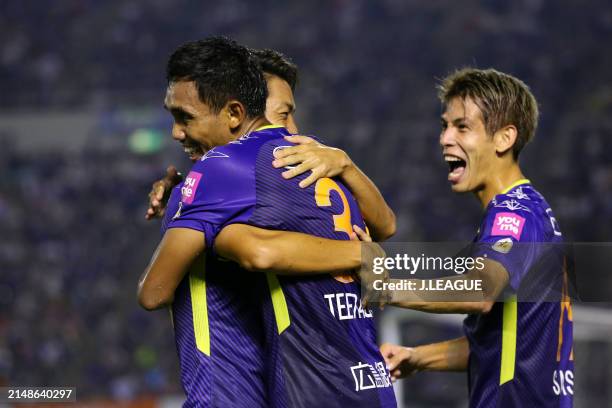 Teerasil Dangda of Sanfrecce Hiroshima celebrates with teammates Hayao Kawabe and Sho Sasaki after scoring the team's second goal during the J.League...