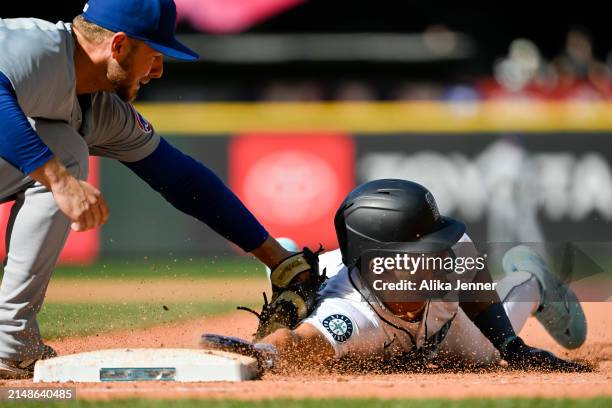 Julio Rodriguez of the Seattle Mariners is picked off at first base by Michael Busch of the Chicago Cubs in the bottom of the ninth inning to end the...