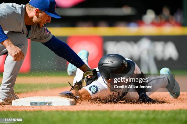 Julio Rodriguez of the Seattle Mariners is picked off at first base by Michael Busch of the Chicago Cubs in the bottom of the ninth inning to end the...